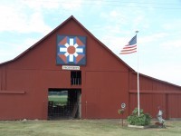 Quilt Barn with American Flag next to it